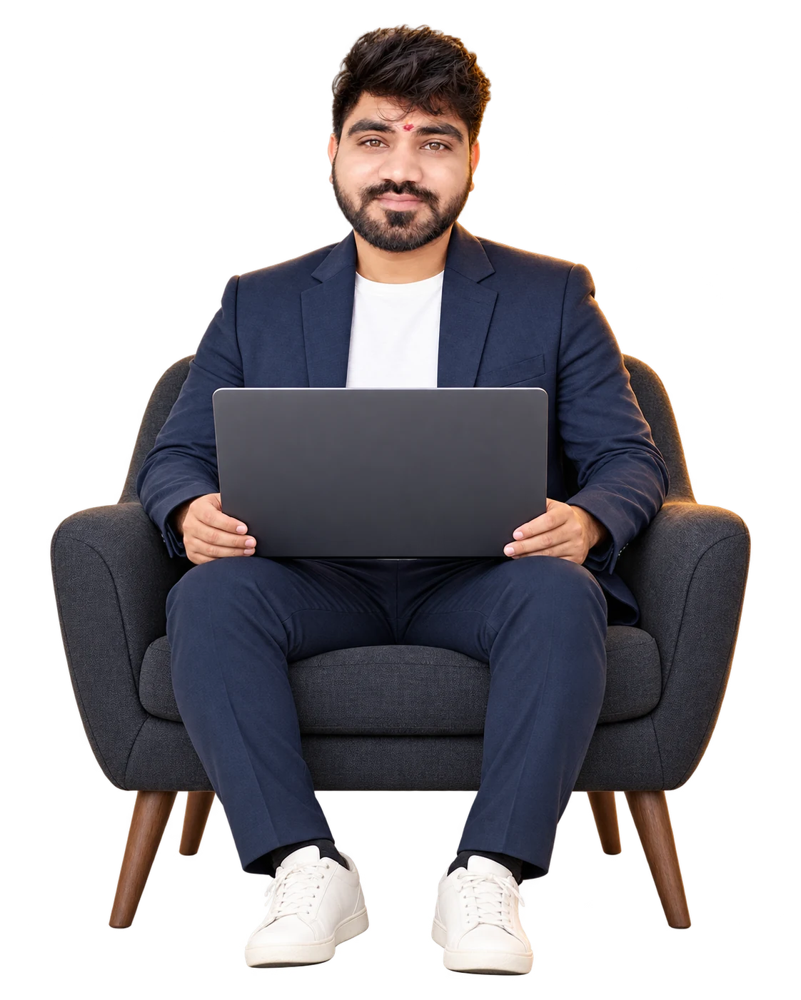 Ajay seated in a chair, holding a laptop on his lap